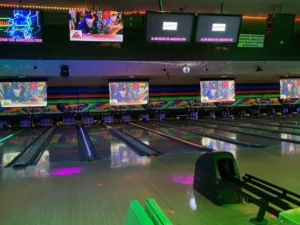 A bowling alley lit up with neon lights for Cosmic Bowling.